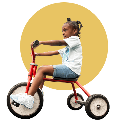 Young girl on a tricycle.