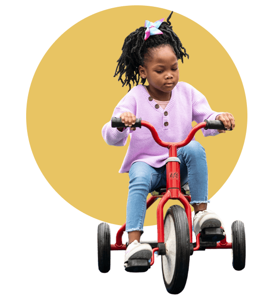 girl riding tricycle