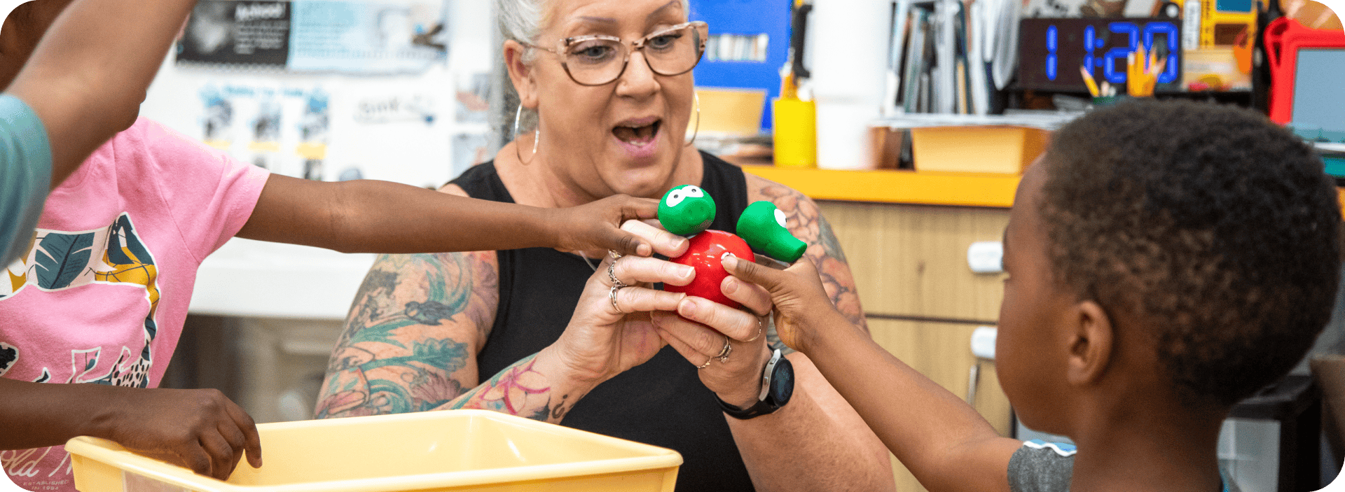 Teacher engaging children in a hands-on educational activity in classroom.