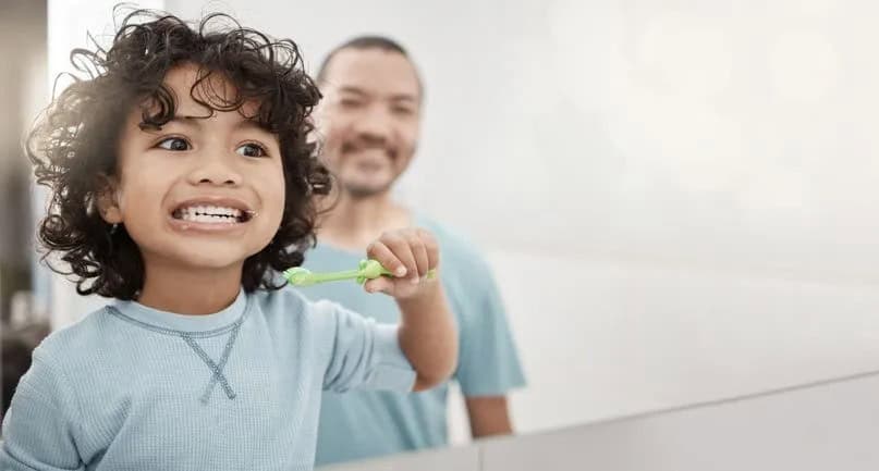 child brushing teeth