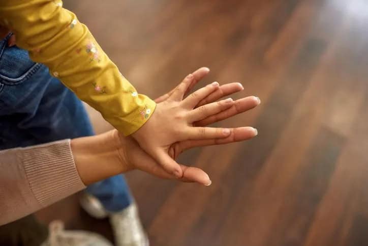 adult and child hand in hand
