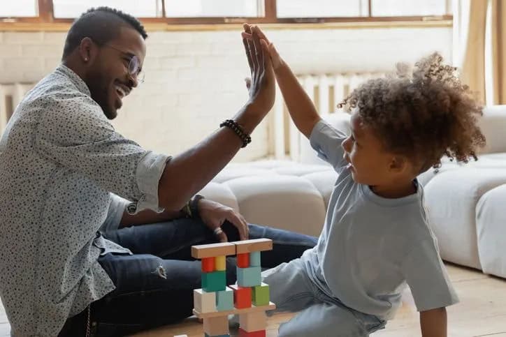 dad and child giving high five